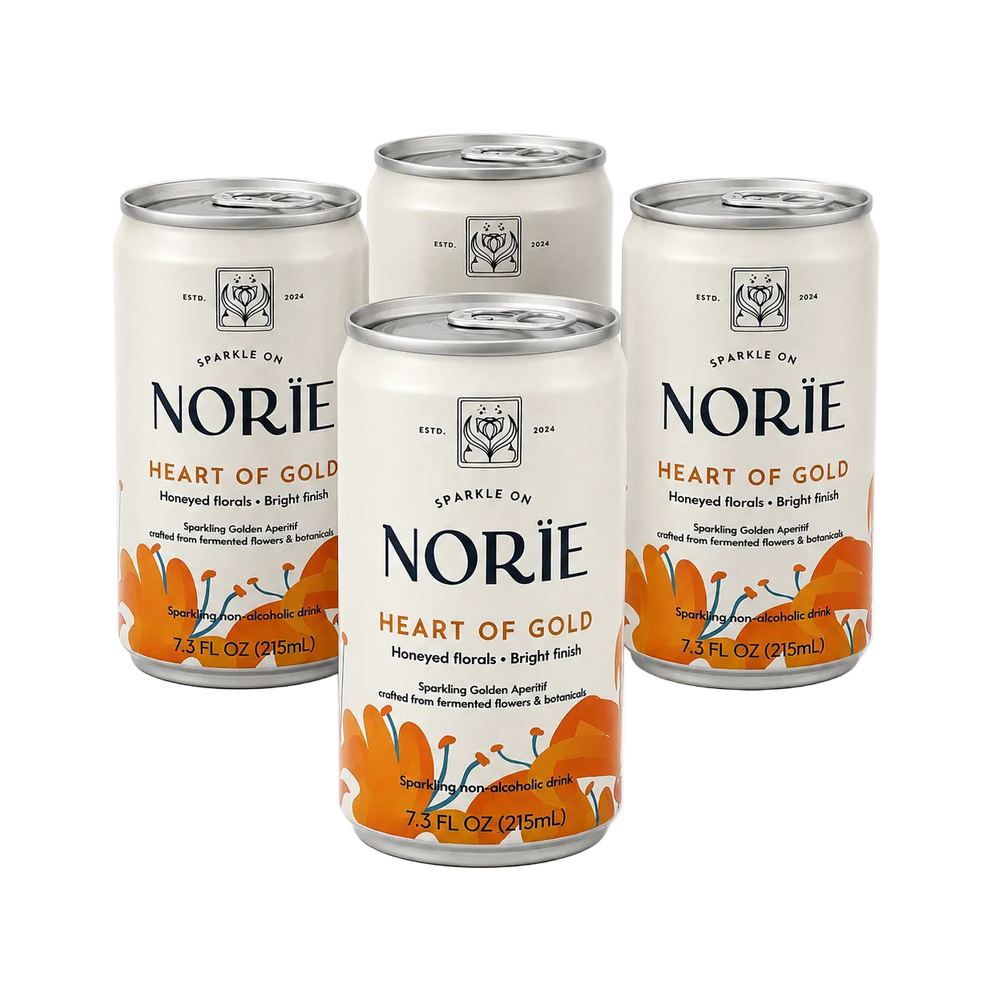 Four 7.3 fl oz cans of Norïe Heart of Gold sparkling non-alcoholic drink arranged in a cluster.
