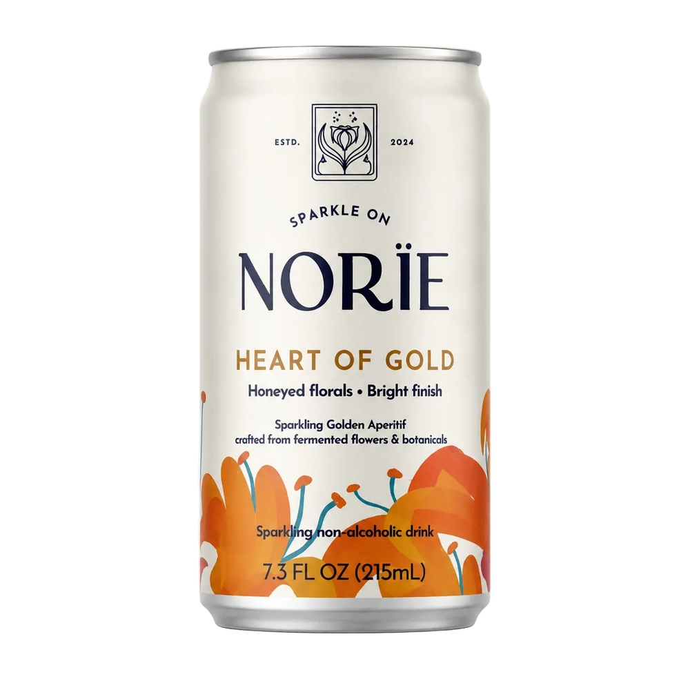 A 7.3 fl oz can of Norïe Heart of Gold sparkling non-alcoholic drink, featuring an off-white label with orange floral illustrations and dark navy branding text.