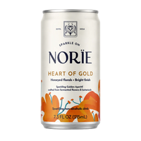 A 7.3 fl oz can of Norïe Heart of Gold sparkling non-alcoholic drink, featuring an off-white label with orange floral illustrations and dark navy branding text.