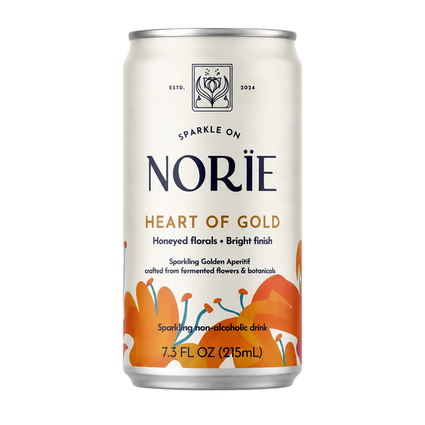 A 7.3 fl oz can of Norïe Heart of Gold sparkling non-alcoholic drink, featuring an off-white label with orange floral illustrations and dark navy branding text.