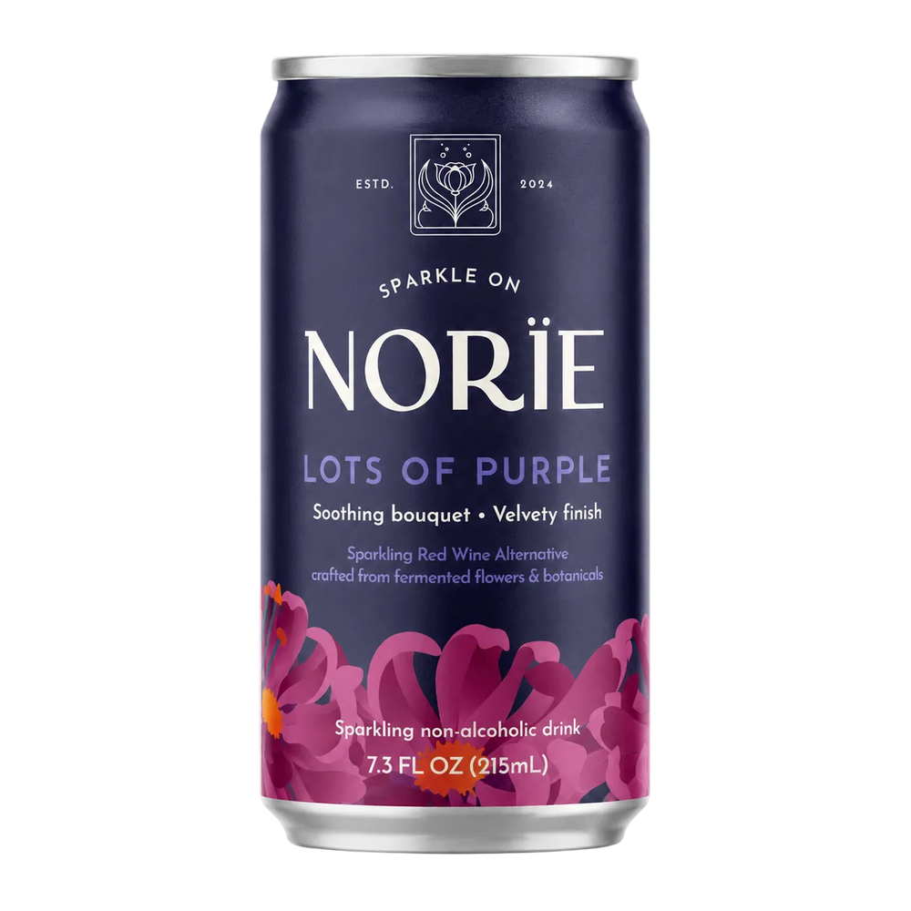A 7.3 fl oz can of Nori’s 'Lots of Purple' sparkling non-alcoholic drink, featuring a deep navy blue label with purple floral graphics and white text, set against a plain white background.