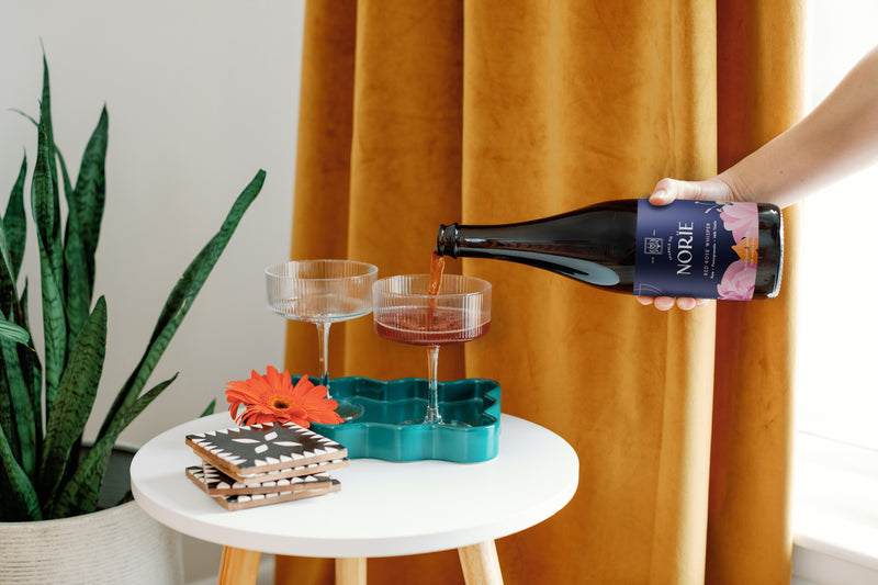 Norïe Red Rose Whisper non-alcoholic sparkling drink being poured into a glass